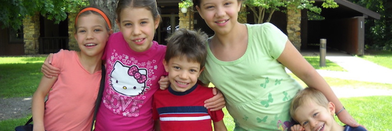 6 Things I Did to Help Find the Diagnosis for My Daughters' Rare Disorder five children smiling and hugging outside