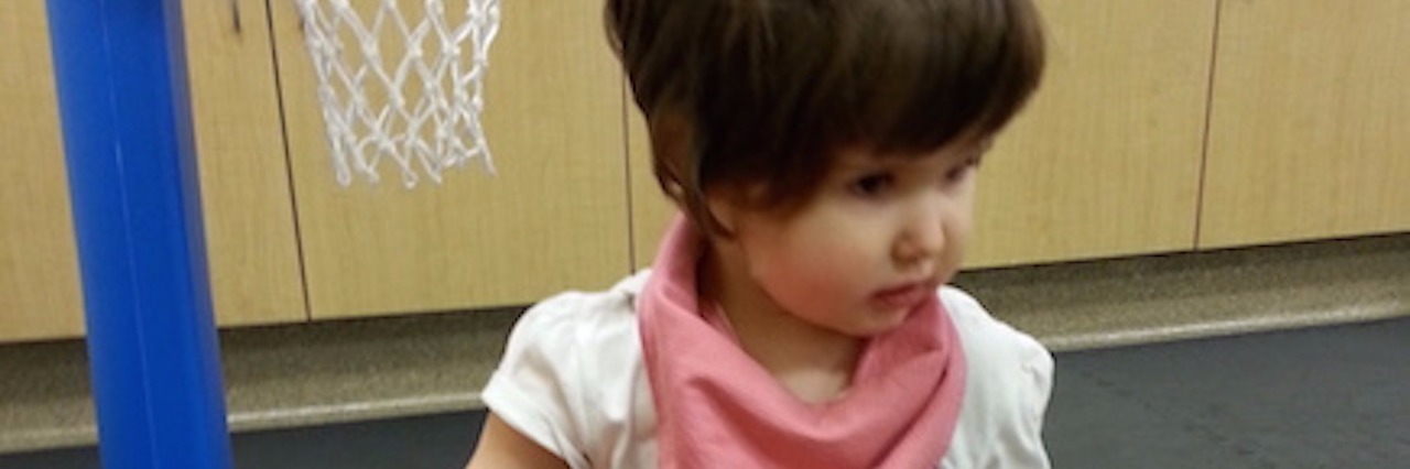 Asking a Special Needs Mom When She Discovered Child's Disability Lyndse's daughter playing next to a small basketball hoop