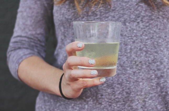 woman holding cocktail