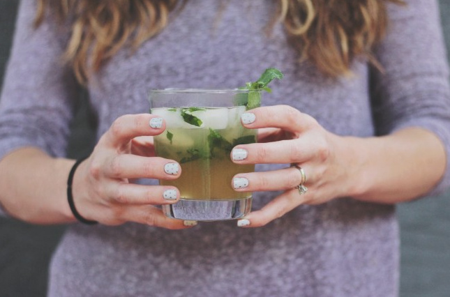 woman holding cocktail