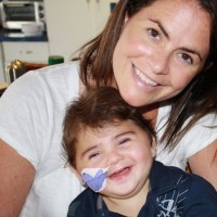 mom and boy with bandage on cheek smiling