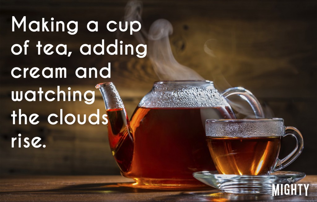 A photo of a teapot and tea cup filled with steaming tea. Accompanying text: [Making a cup of tea, adding cream and watching the clouds rise.]