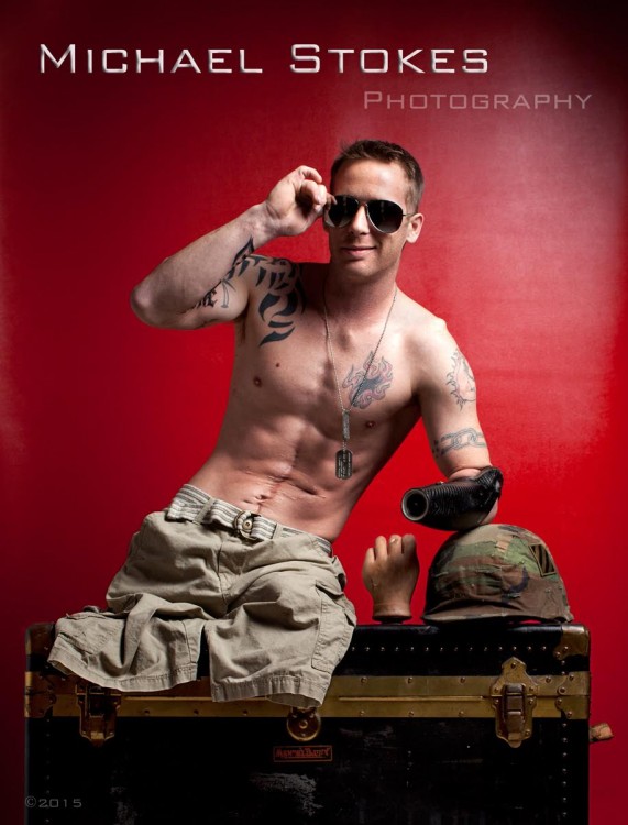 shirtless man with no legs, smiling and wearing sunglasses