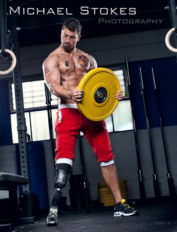 man with prosthetic leg lifting a weight