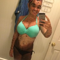 Girl poses in bikini in bathroom