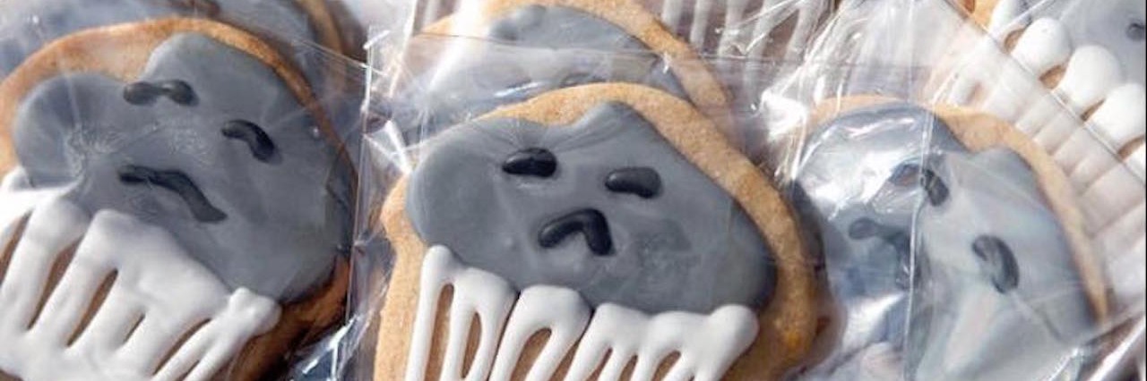 depressed cookies with gray frosting and frowny faces