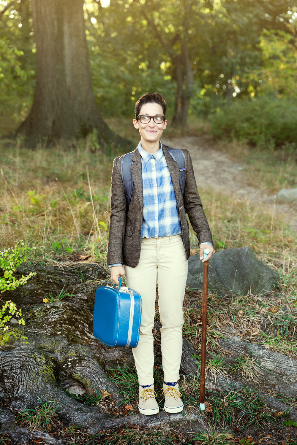 Liz Jackson poses outside with cane and briefcase