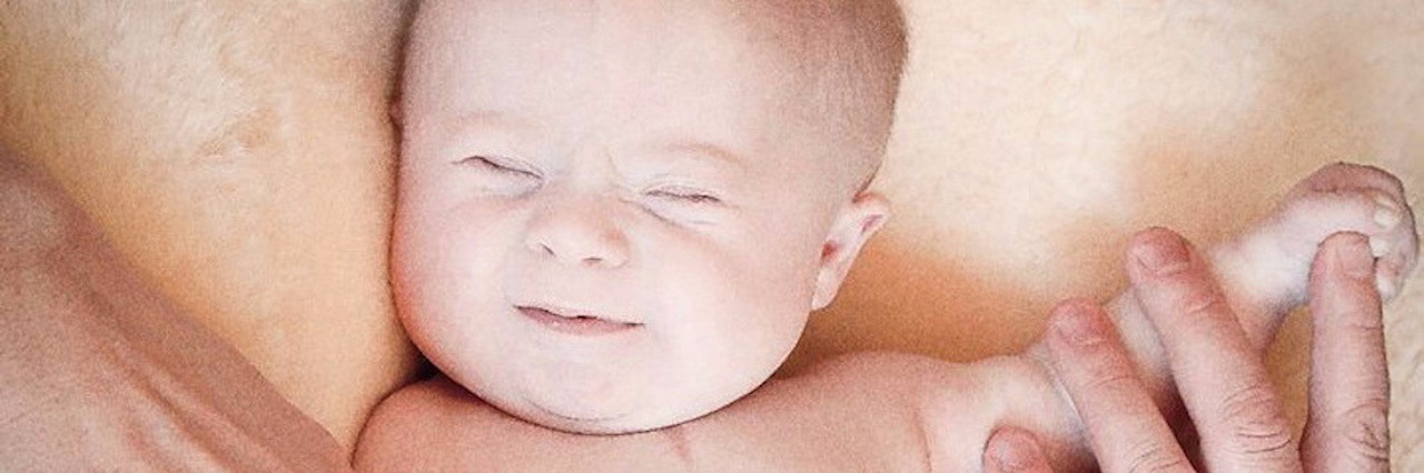 What to Know About a Down Syndrome Diagnosis Ange Longbottom, baby with parents' hands