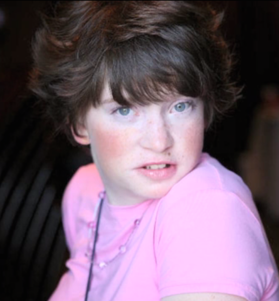 photograph of young girl in a pink shirt