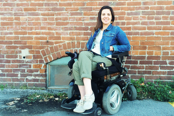 Heidi McKenzie sitting outside in her wheelchair