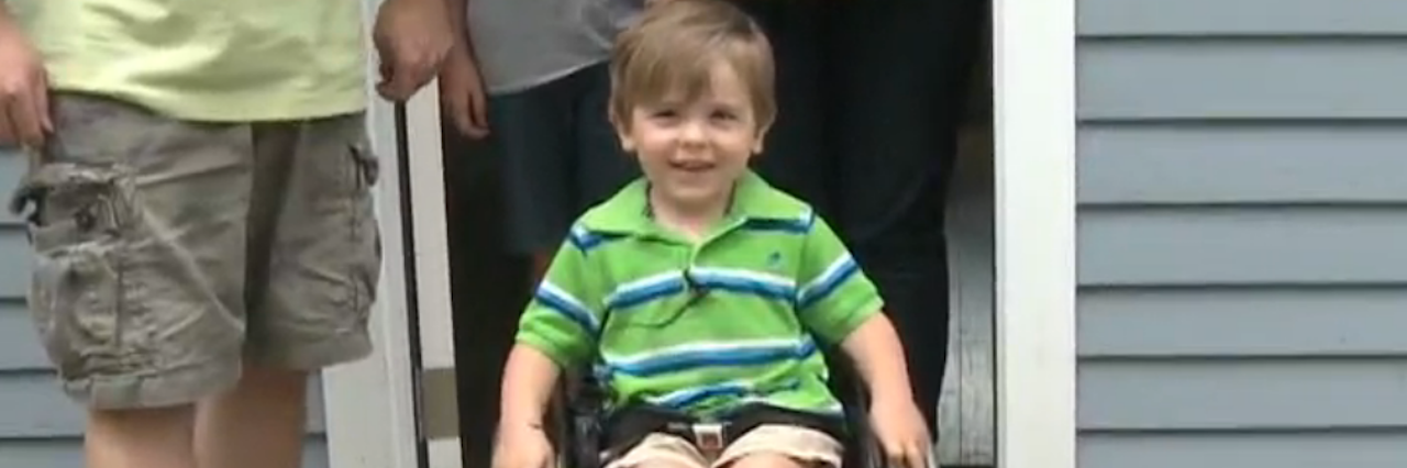 Paralyzed 3-Year-Old Asks for a Make-A-Wish to Help His Dad young boy smiling in wheelchair