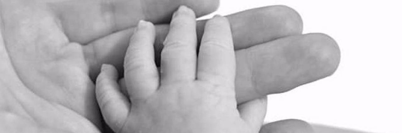 Letter to My Baby Son From a Breast Cancer Survivor mother's hand holding baby's hand