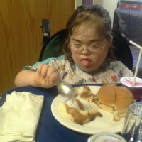 Girl with Down syndrome eating food
