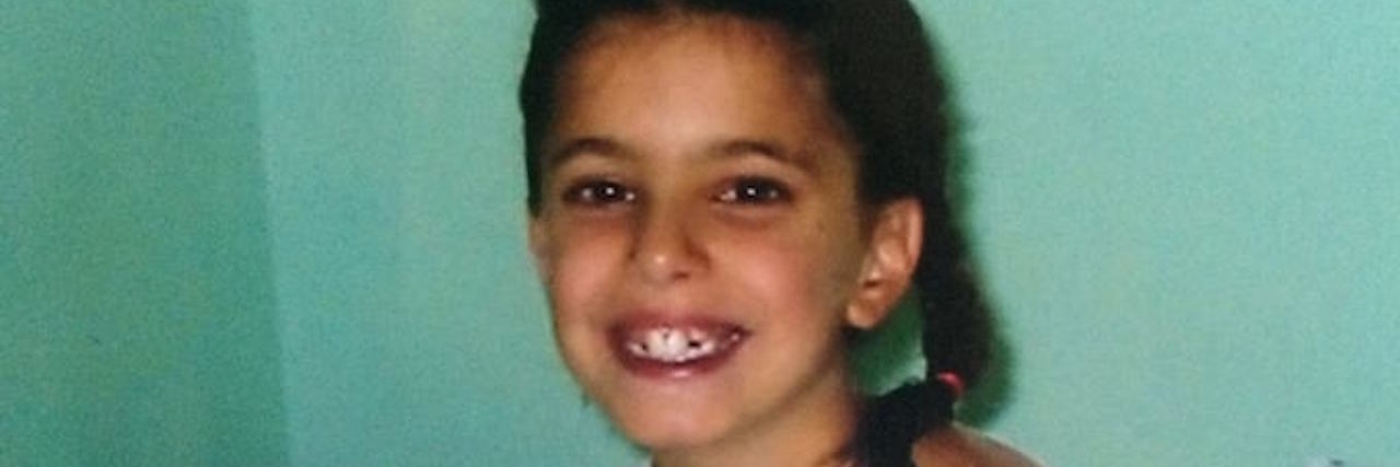 To the Parents of a Child With Chronic Illness A girl in a hospital gown holding a teddy bear