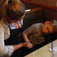 Waitress sitting with young boy