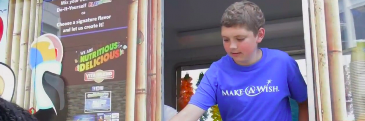 12-Year-Old Cancer Patient Uses His 1 Wish to Feed Hospital Patients and Staff Boy wearing a Make a Wish t-shirt hands out food from a food truck