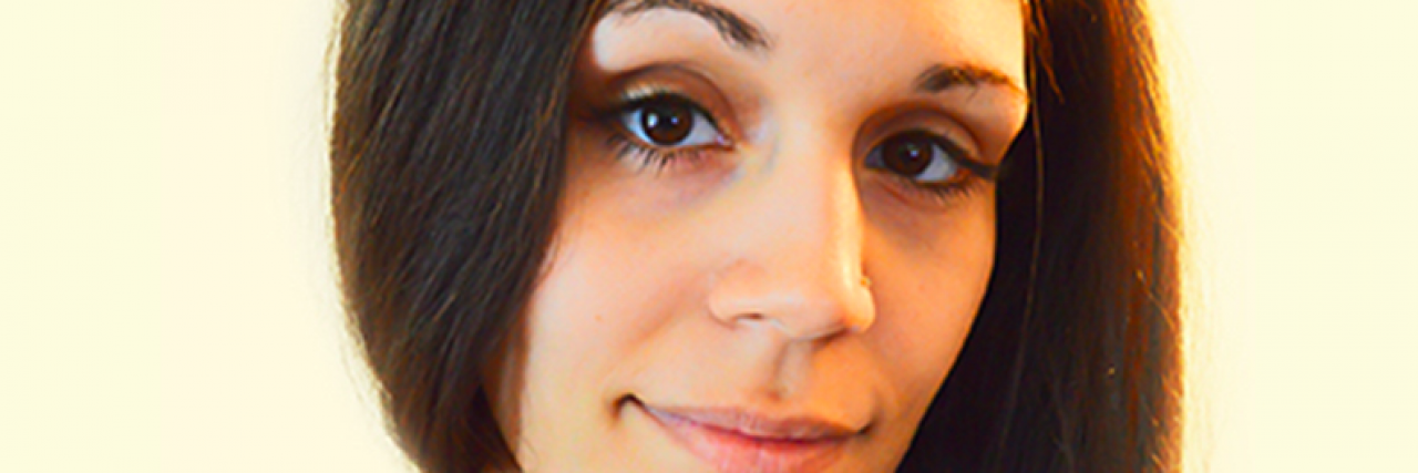 What to Do (and Not Do) If You See Me Having a Seizure Woman with brown hair smiles slightly