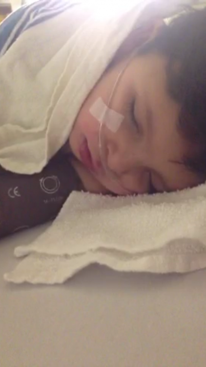 the author's son with oxygen tubes, sleeping on a hospital bed