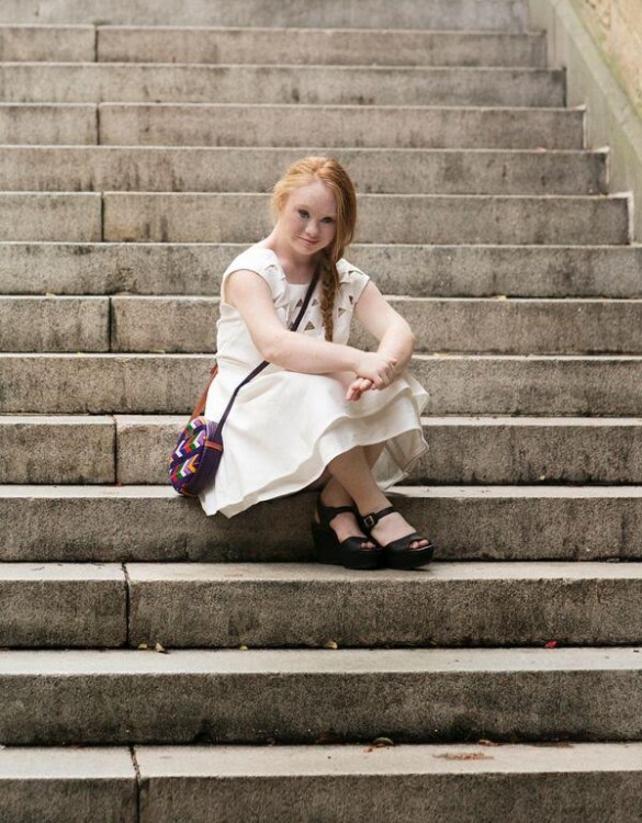 Madeline Stuart sitting on steps