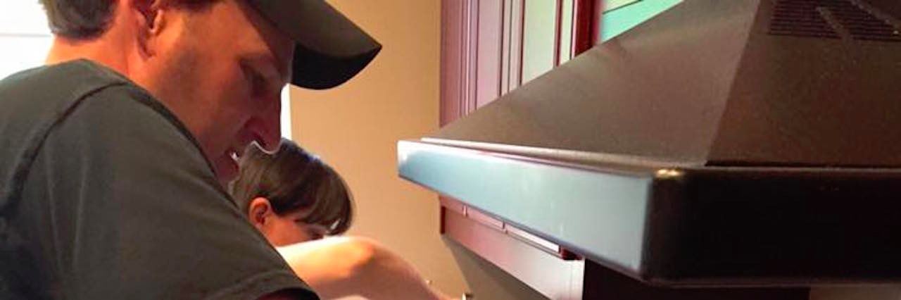 The Crayon Initiative Redistributes Restaurants' Leftover Crayons dad stirring melted crayons in pot