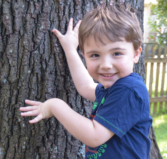 boy next to tree