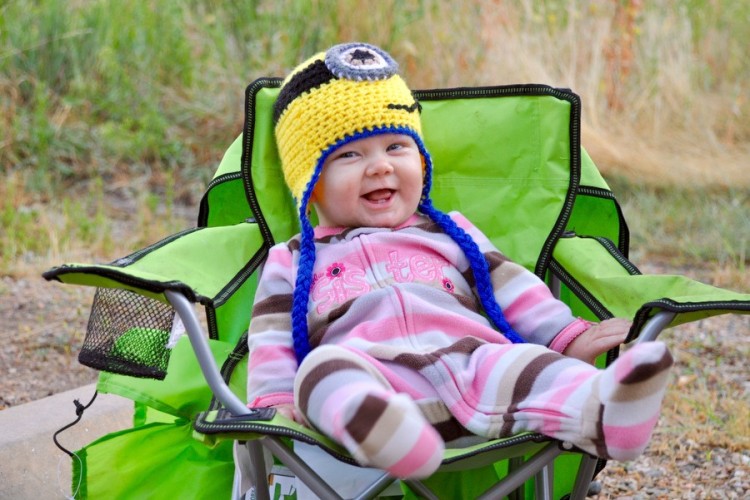 young girl sitting outside and smiling