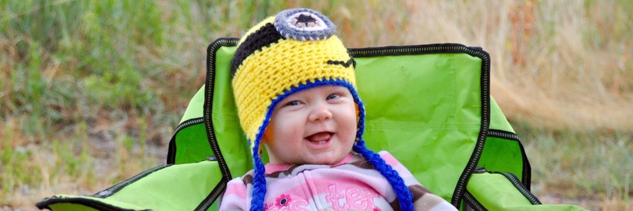 Asking Rare Disease Parents If They Also Want 'Normal' Children young girl sitting outside and smiling