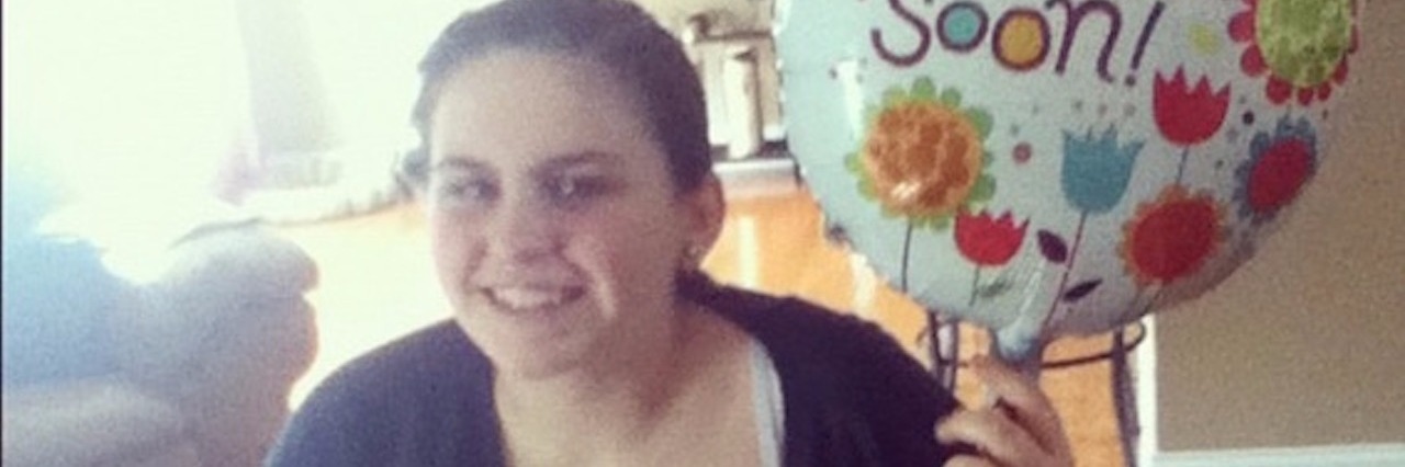 What I Wish Parents of Children With Chronic Illness Understood young woman with 'get well soon' balloon and teddy bear