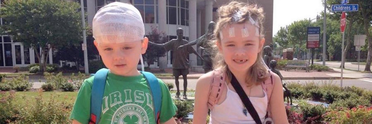 Caring for Yourself While Caring for a Loved One With Special Needs two children sitting on a bench holding hands
