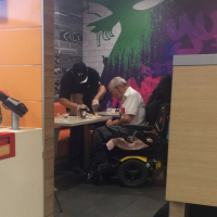McDonald's employee helps man with disabilities eat his food
