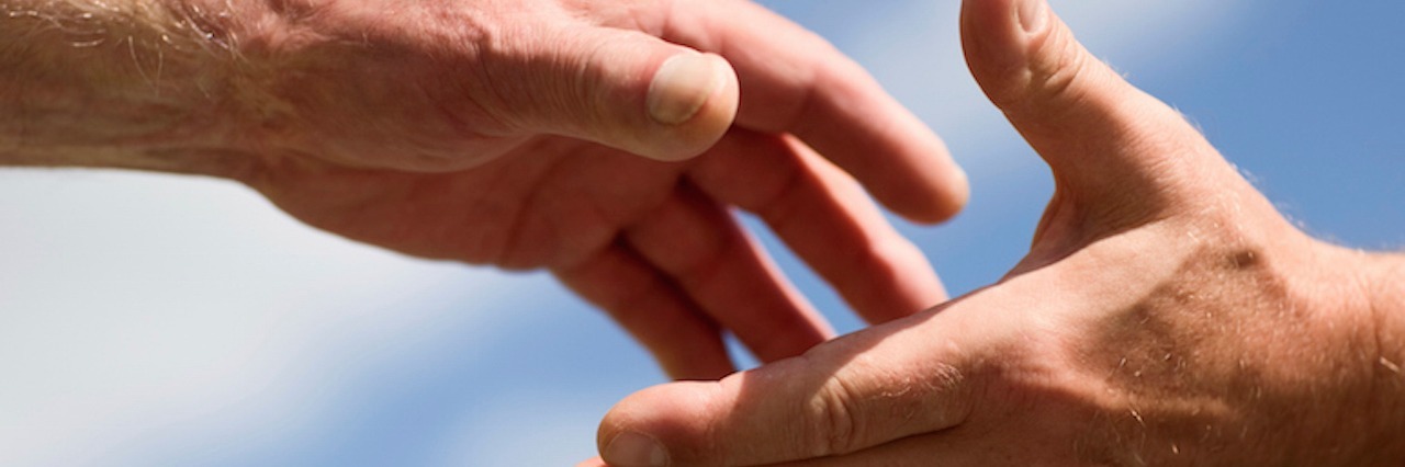 What to Do if You Think Someone Is Having Suicidal Thoughts hand reaching out to another