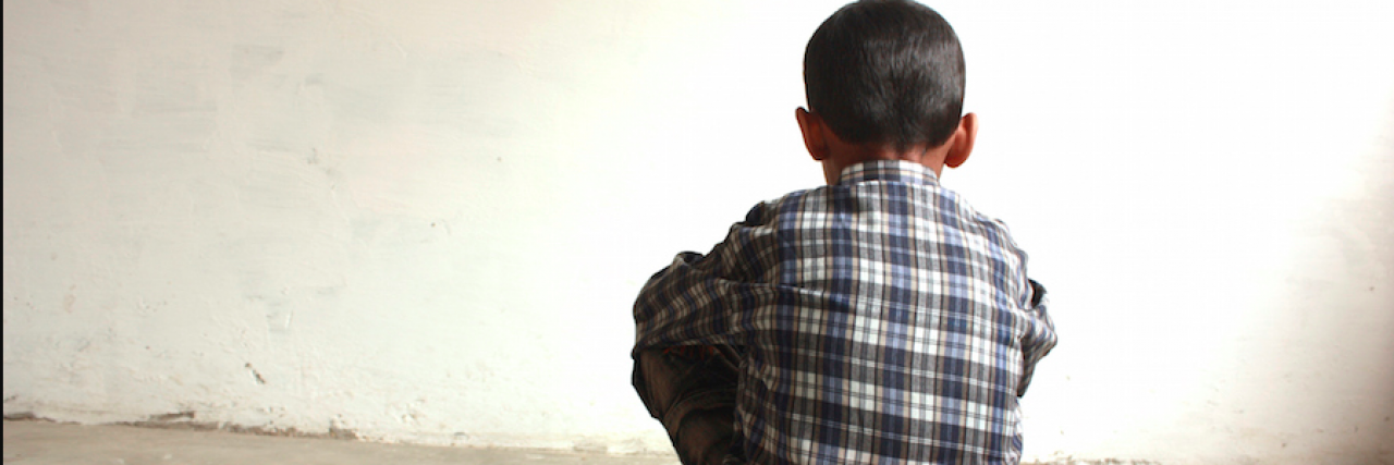 When Your Child Can't Tell You He's Experiencing Psychosis Image of boy sitting with his back to the camera