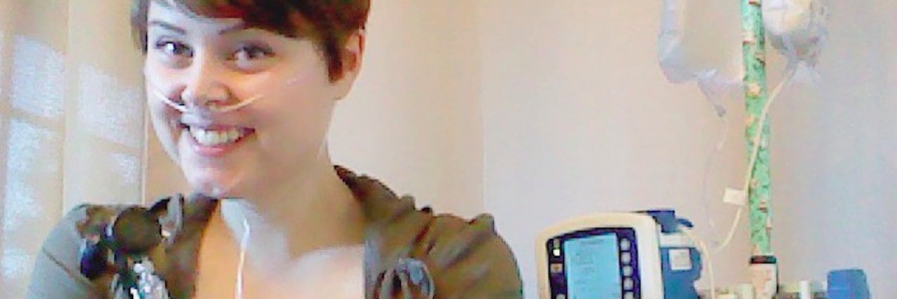 When Your Full-Time Job Becomes 'Professional Patient' A woman with tubes attached to her nose holds oxygen tank