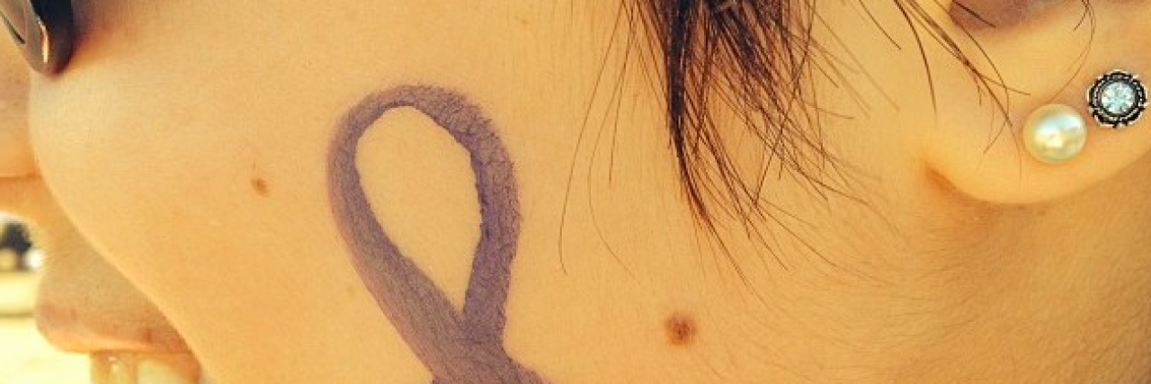 10 Things I Wish People Understood About Invisible Illnesses Side view of person's face with awareness ribbon painted onto it