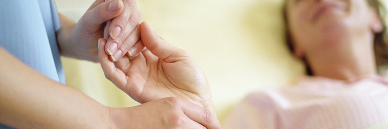 Owing My Life to Nurses After a Long Hospital Stay Nurse checking female patient's pulse on wrist, close-up