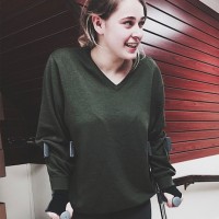 Girl stands in hallway with crutches