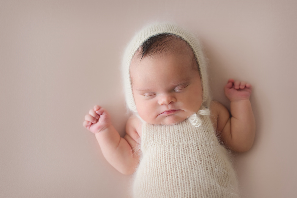 Baby Abigail sleeping on link pink background