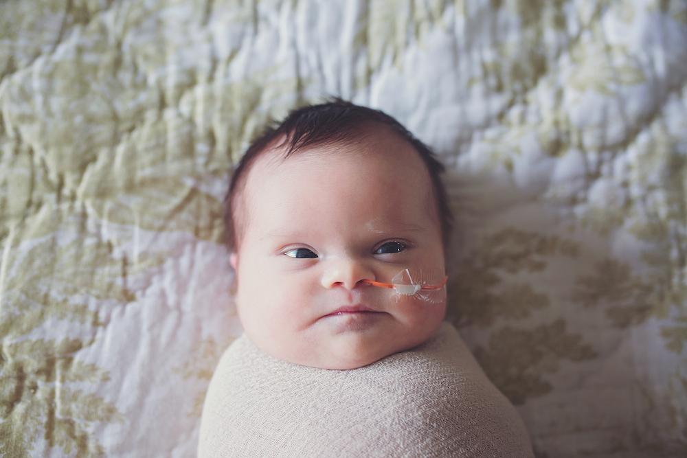 Erika and Stephen Jones' daughter Abigail on a bed