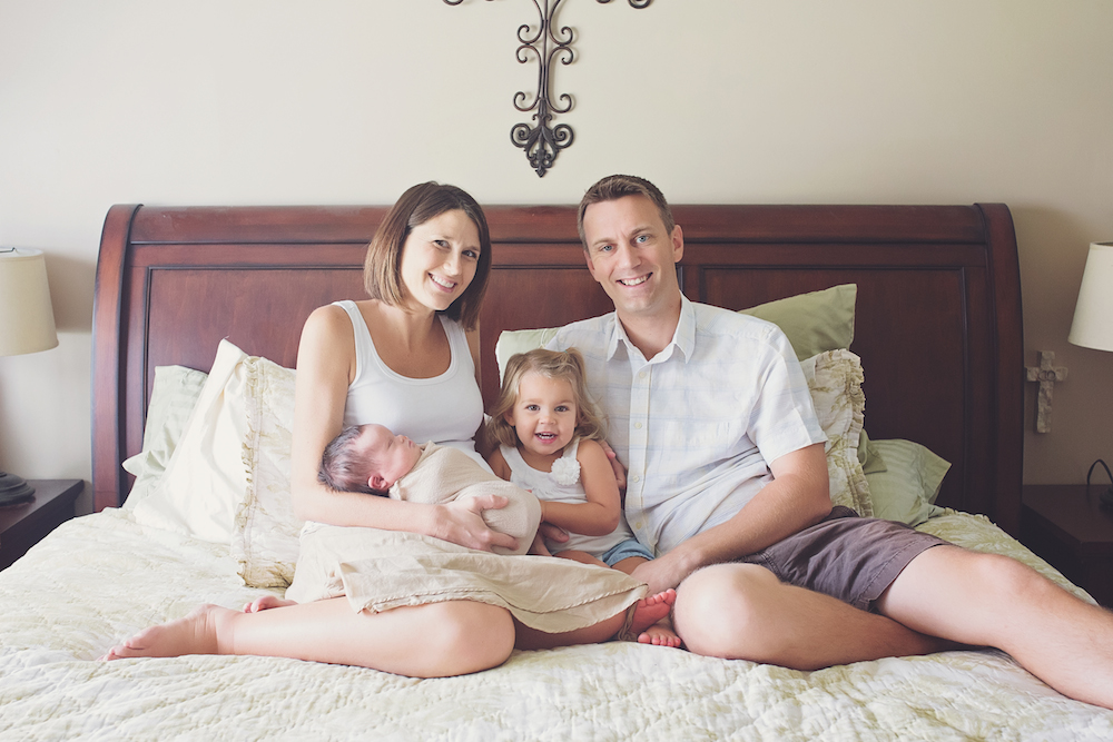 The Jones family sitting on a bed