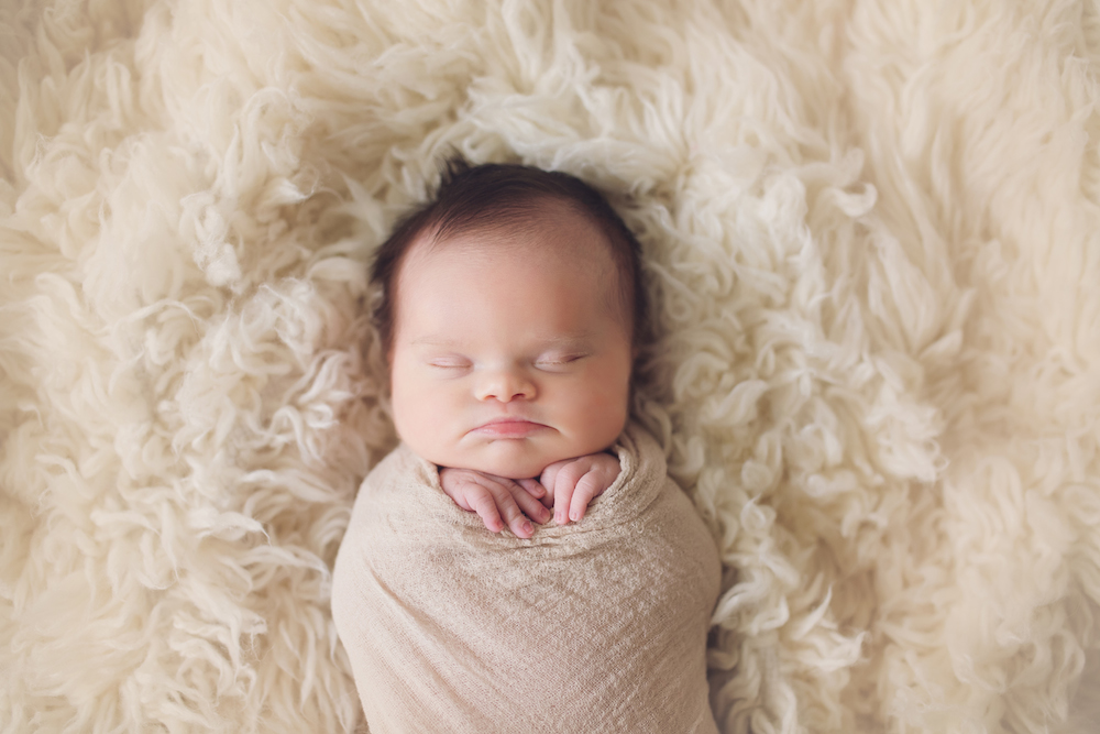 Baby Abigail sleeping on a rug