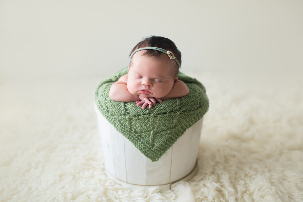 Baby Abigail sleeping in a white container