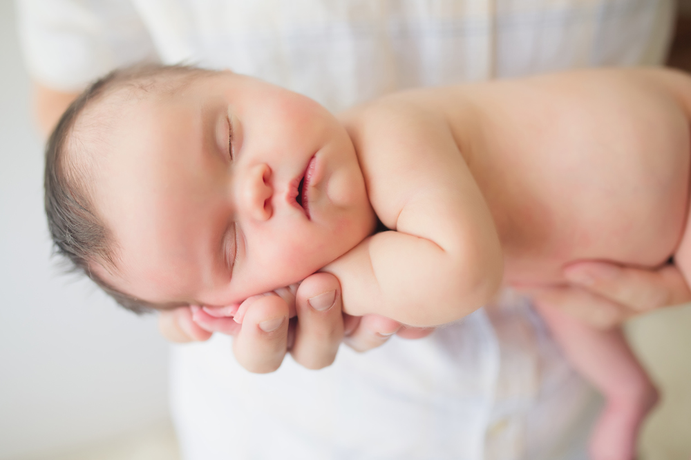 Baby Abigail sleeping in someone's arms