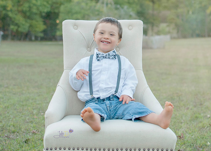 Boy sitting in chair in a park