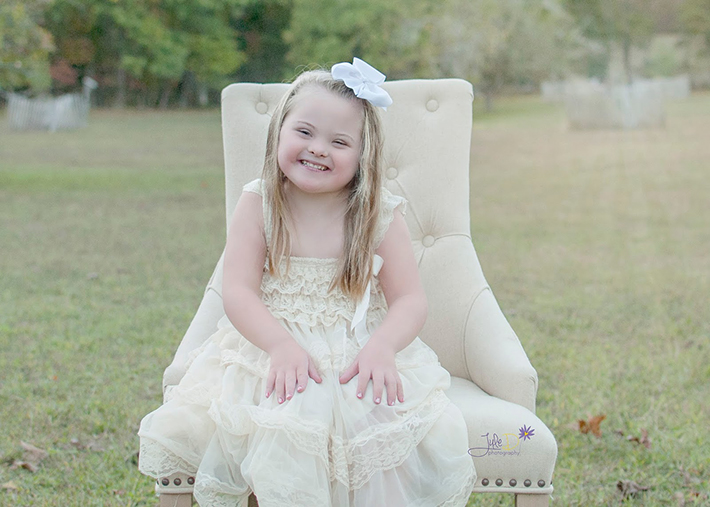 Girl sitting in chair in a park