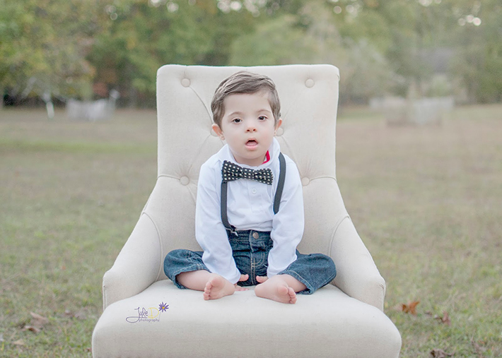 Boy sitting on a chair in a park