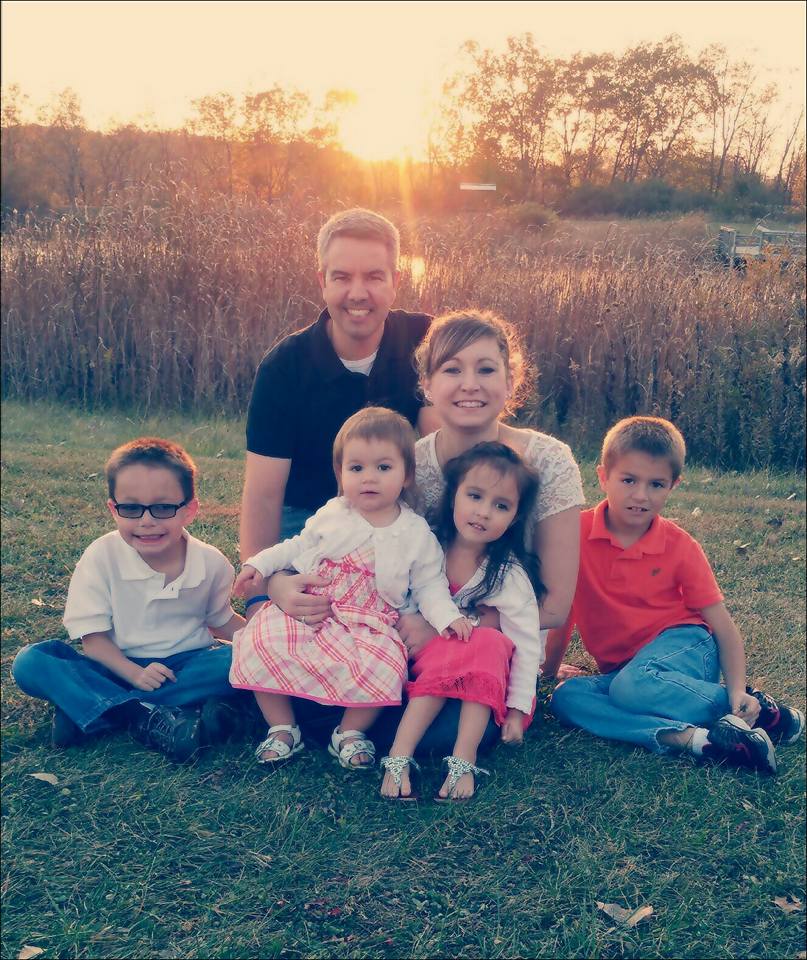 Family of six smiling at sunset. 