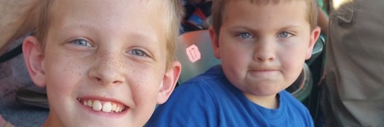 Man Joked That My Child With Cerebral Palsy Was Drunk two young boys in a stadium