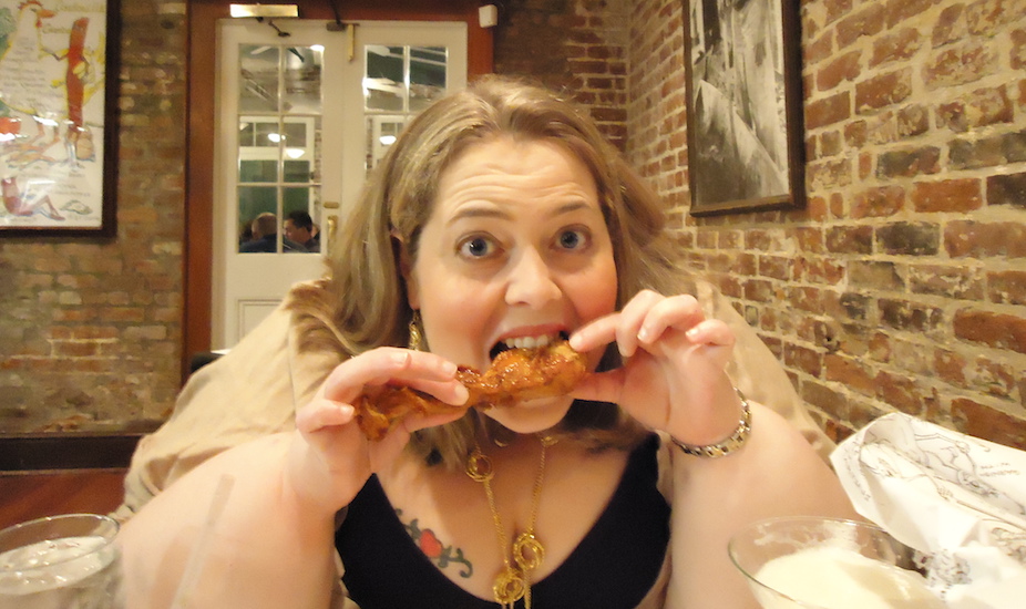 woman eating a chicken wing
