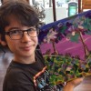 boy holding colorful painting