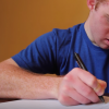 man with down syndrome writing a letter